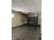 Attached garage with overhead door, concrete floor and shelving at 2620 Janet St, Kissimmee, FL 34741