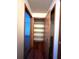 Hallway with a linen closet and wood flooring at 2620 Janet St, Kissimmee, FL 34741