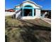 Single story home with teal window accents and a grassy yard at 2620 Janet St, Kissimmee, FL 34741