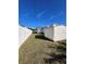 Side view of the house with a white fence and a shed at 2620 Janet St, Kissimmee, FL 34741