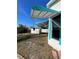 Side of house with teal accents and a detached shed at 2620 Janet St, Kissimmee, FL 34741