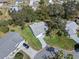 Aerial view of single-Gathering home with a large yard and driveway at 26548 Deuce Ct, Leesburg, FL 34748