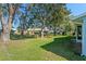 Spacious backyard with mature trees and lush lawn at 26548 Deuce Ct, Leesburg, FL 34748