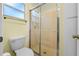 Clean bathroom with a toilet and a glass shower door at 26548 Deuce Ct, Leesburg, FL 34748