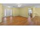 Bright entryway with wood-look floors and view into the kitchen at 26548 Deuce Ct, Leesburg, FL 34748