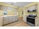 Kitchen with stainless steel appliances and light wood cabinets at 26548 Deuce Ct, Leesburg, FL 34748