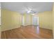 Light and airy living room with light wood floors and neutral walls at 26548 Deuce Ct, Leesburg, FL 34748