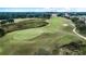 Aerial view of a golf course with a green and sand traps at 26715 Manassas Dr, Leesburg, FL 34748