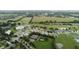 Aerial view of community featuring a golf course and tennis courts at 26715 Manassas Dr, Leesburg, FL 34748