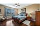 Well-lit bedroom with a queen-size bed and hardwood floors at 26715 Manassas Dr, Leesburg, FL 34748