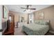 Guest bedroom with a double bed, ceiling fan, and wood floors at 26715 Manassas Dr, Leesburg, FL 34748