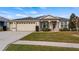 One-story home with two-car garage and manicured lawn at 26715 Manassas Dr, Leesburg, FL 34748