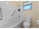 Bathroom with tub, toilet, and grab bars at 26912 Tanner St, Leesburg, FL 34748