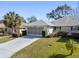 Single-story house with a garage and nicely landscaped front yard at 26912 Tanner St, Leesburg, FL 34748