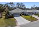 Two-unit property with garages, shared driveway, and lush landscaping at 26912 Tanner St, Leesburg, FL 34748