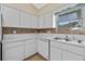 Kitchen corner with white cabinets and double sink at 26912 Tanner St, Leesburg, FL 34748