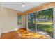 Bright sunroom with wood floors and sliding glass doors at 26912 Tanner St, Leesburg, FL 34748