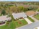 Aerial view with property boundaries marked in red, showing lawn and mature landscaping at 26913 Racquet Cir, Leesburg, FL 34748