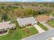 Aerial shot of a well-kept property with green lawn, mature landscaping and proximity to neighboring homes at 26913 Racquet Cir, Leesburg, FL 34748