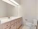 Bathroom boasts a large mirror above the vanity, providing ample light and reflection in a clean space at 26913 Racquet Cir, Leesburg, FL 34748