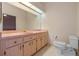 Bathroom with pink vanity and toilet at 26913 Racquet Cir, Leesburg, FL 34748