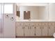 Bathroom featuring a bright vanity with ample cabinet space, a framed mirror, and a glass enclosed shower at 26913 Racquet Cir, Leesburg, FL 34748
