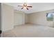 Bright bedroom with ceiling fan and ample closet space at 26913 Racquet Cir, Leesburg, FL 34748