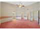 Large bedroom with walk in closet and ceiling fan at 26913 Racquet Cir, Leesburg, FL 34748