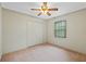 Well-lit bedroom, featuring a ceiling fan and double door closet at 26913 Racquet Cir, Leesburg, FL 34748