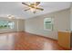 Bright bonus room featuring wood flooring and dual ceiling fans at 26913 Racquet Cir, Leesburg, FL 34748