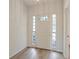 Inviting front entry door with decorative sidelights, creating a welcoming entrance at 26913 Racquet Cir, Leesburg, FL 34748