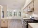 Bright kitchen featuring stainless steel appliances, a breakfast bar, and adjacent dining area at 26913 Racquet Cir, Leesburg, FL 34748