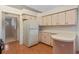 Kitchen boasts a refrigerator and corner counter at 26913 Racquet Cir, Leesburg, FL 34748