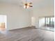 Bright living room featuring wood floors, a ceiling fan, and sliding glass doors to the patio at 26913 Racquet Cir, Leesburg, FL 34748