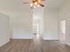 Open-concept living room featuring wood floors, ceiling fan, and view of the front entrance at 26913 Racquet Cir, Leesburg, FL 34748