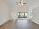 Bright living room featuring wood floors, a ceiling fan, and sliding glass doors to the patio at 26913 Racquet Cir, Leesburg, FL 34748