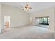 Bright living room with high ceilings, carpet, and sliding glass doors at 26913 Racquet Cir, Leesburg, FL 34748