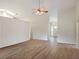 Inviting living room with wood floors, ceiling fan, and bright natural light at 26913 Racquet Cir, Leesburg, FL 34748
