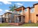 View of multiple townhomes, each with a screened patio and backyard at 2713 Impala Ln, Kissimmee, FL 34746