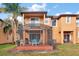 Screened patio with table and chairs, adjacent to a two-story townhome at 2713 Impala Ln, Kissimmee, FL 34746