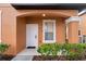 White front door with a decorative archway and landscaping at 2713 Impala Ln, Kissimmee, FL 34746