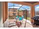 Relaxing screened patio with table, chairs, and grill at 2713 Impala Ln, Kissimmee, FL 34746