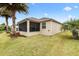 House exterior showcasing a screened porch and manicured lawn at 2954 Silk Tree Ter, The Villages, FL 32163