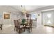 Bright dining area with glass-top table and seating for six at 2954 Silk Tree Ter, The Villages, FL 32163