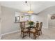 Dining area with glass top table and kitchen view at 2954 Silk Tree Ter, The Villages, FL 32163