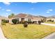 One story house with a two car garage and manicured lawn at 2954 Silk Tree Ter, The Villages, FL 32163