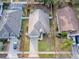 Aerial view of a green house and surrounding neighborhood at 30111 Pga Dr, Mount Plymouth, FL 32776