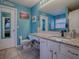 Bathroom with teal walls, granite countertop, and white cabinets at 30111 Pga Dr, Mount Plymouth, FL 32776