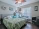 Comfortable bedroom with a queen-size bed and ensuite sitting area at 30111 Pga Dr, Mount Plymouth, FL 32776