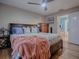 Main bedroom with king-size bed, dresser, and access to bathroom at 30111 Pga Dr, Mount Plymouth, FL 32776